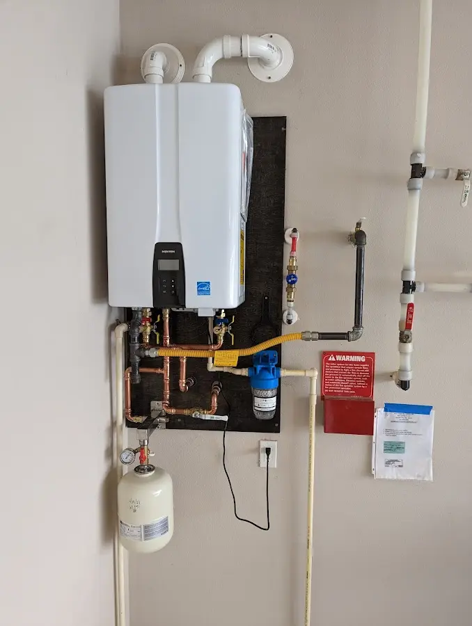 Professional plumber installing copper piping in a Auburn home